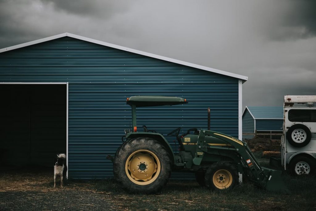 Metal shed with a tractor parked in front